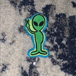 Green alien badge reel